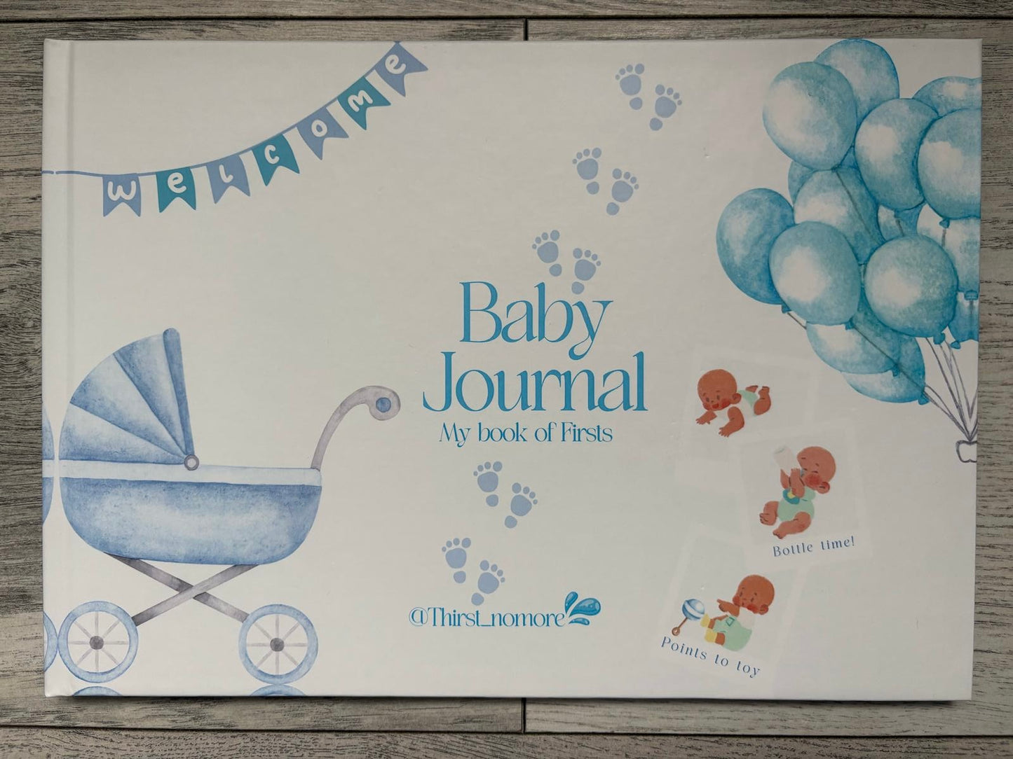 Cover of a boys 'Baby Journal' featuring illustrations of a baby carriage, balloons, and decorative elements in blue color on a white background.